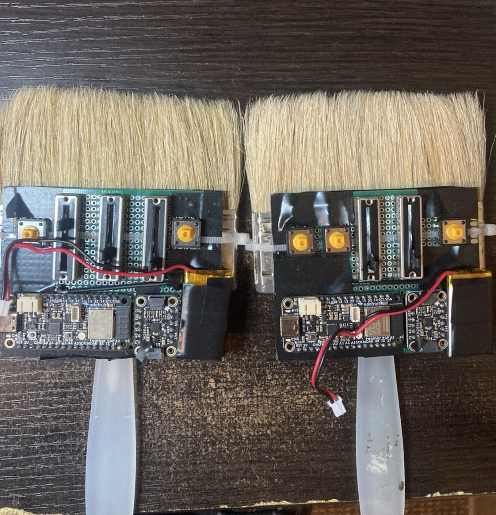 Two hand brush controllers with ESP32 boards and batteries